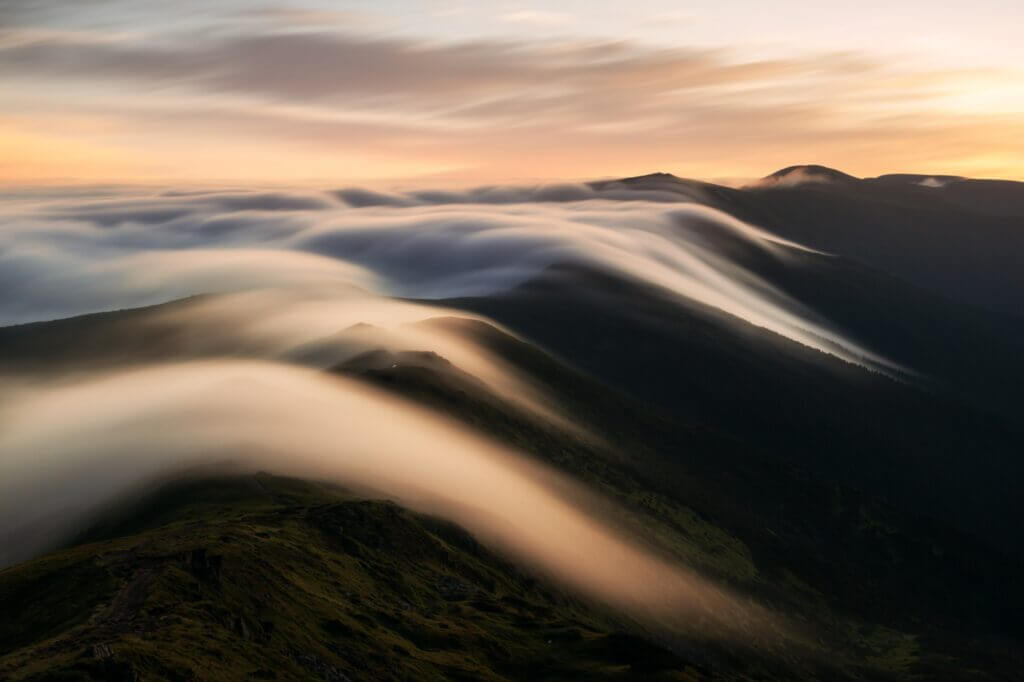 Amazing flowing morning fog in spring mountains