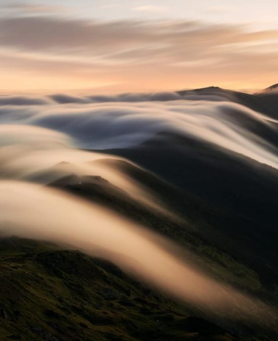 Amazing flowing morning fog in spring mountains